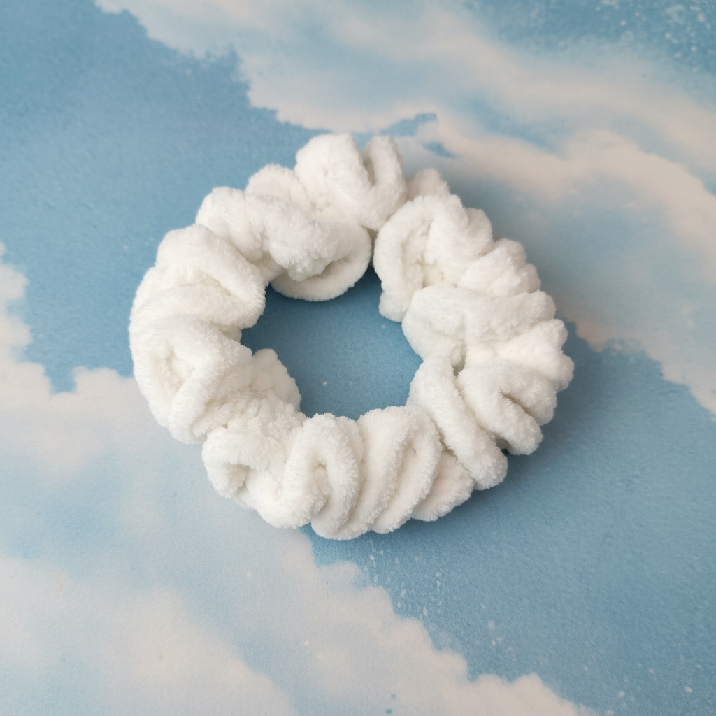 White velvet scrunchie on patina blue background