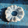 Sky blue and white two-tone velvet scrunchie on patina blue background