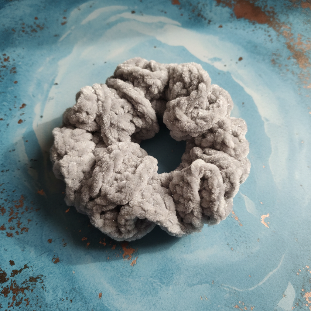 Grey sparkle scrunchie on patina blue background